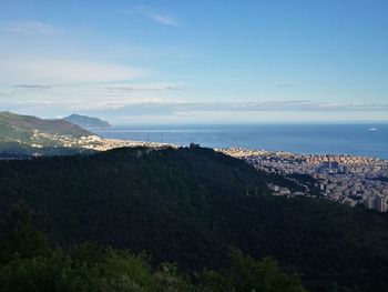 High angle view of cityscape by sea against sky