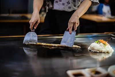 Midsection of person preparing food