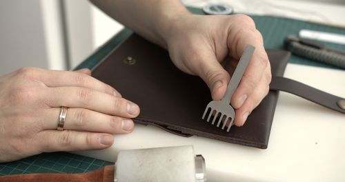 Cropped hands of man working on table