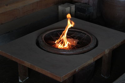 High angle view of burning candles on wood