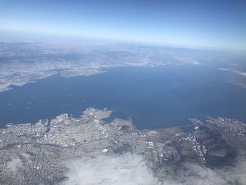 Aerial view of sea and cityscape against sky