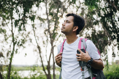 Man looking away standing at park