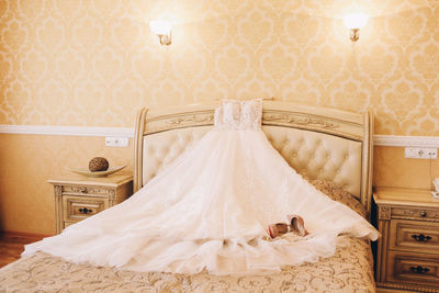 Dress on bed against wall at home