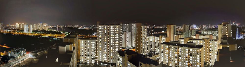 High angle view of illuminated city buildings at night