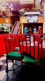 Empty chairs and tables arranged in restaurant