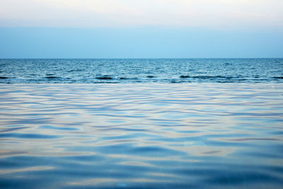 Infinity pool by sea against sky