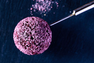 High angle view of pink ice cream against black background