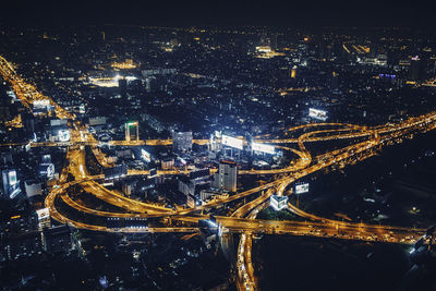 High angle view of illuminated city buildings at night