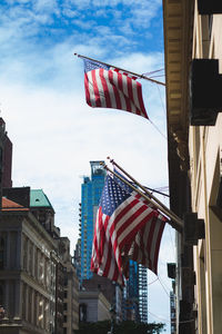 Low angle view of flags against buildings