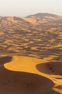 Scenic view of desert against sky during sunset