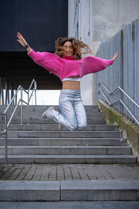 Rear view of woman standing on staircase