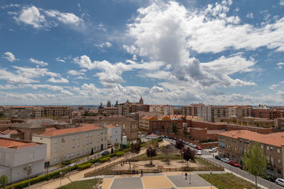 High angle view of road by buildings against sky