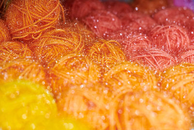 Close up of multicolored yarn balls in knitting shop center. a lot of color yarn for knitting