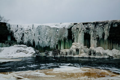 Frozen lake against sky during winter