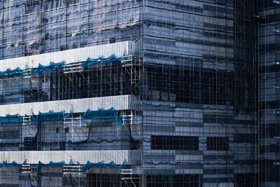 Low angle view of modern glass building in city