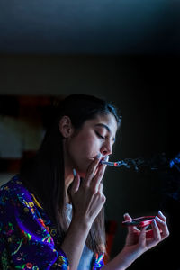 Close-up of young woman smoking