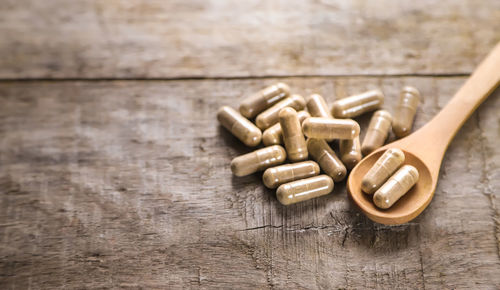 High angle view of pills on wooden table