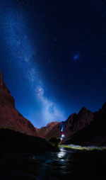 Scenic view of illuminated mountains against sky at night