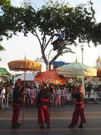 Group of people with umbrellas on street in city