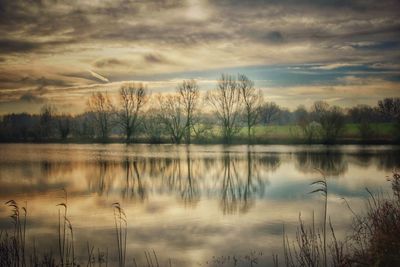 Scenic view of lake against cloudy sky