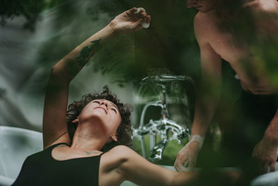 Portrait of woman holding hands in water