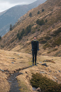 Rear view of man standing on mountain