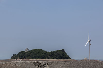 Windmill on daebudo island against blue sky