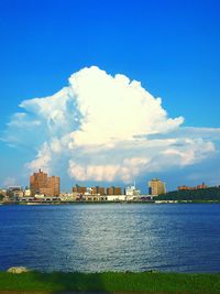 Buildings in city against cloudy sky