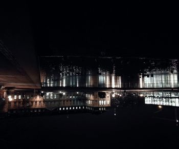 Illuminated city against sky at night