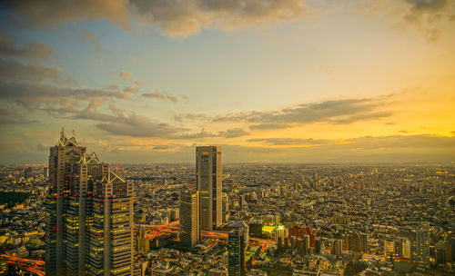 High angle view of modern buildings against sky during sunset