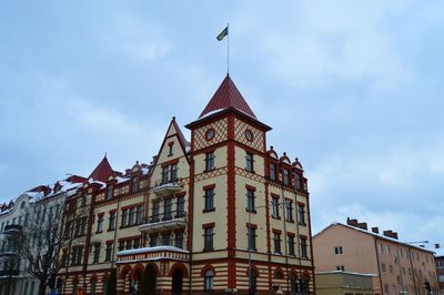 Low angle view of building against cloudy sky