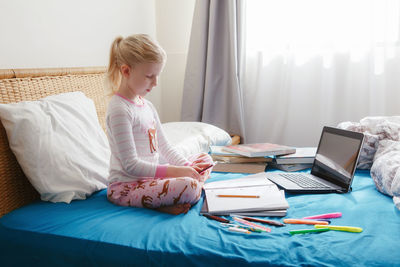 Woman sitting on table at home