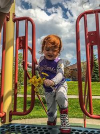 Full length of boy playing on slide at playground