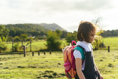 Girl standing in school yard in a rural setting