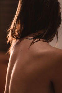 Rear view of shirtless woman