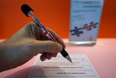 Male hand filling up ballot paper