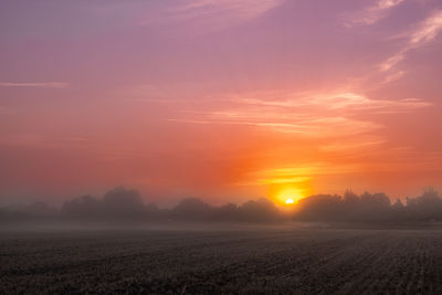 A magical sunrise across the fields of north norfolk on a misty and atmospheric morning