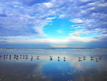 Scenic view of sea against cloudy sky