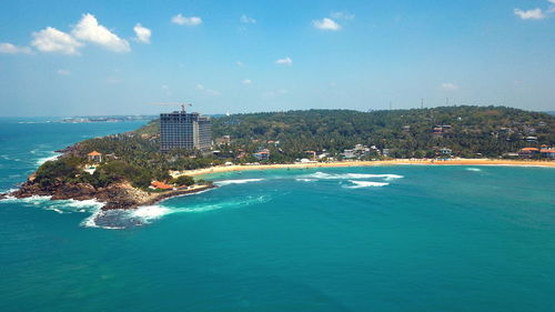 Scenic view of sea and buildings against sky