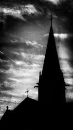 Low angle view of church against cloudy sky