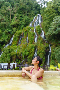 Young woman sitting on rock