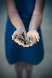 Midsection of woman holding fruit