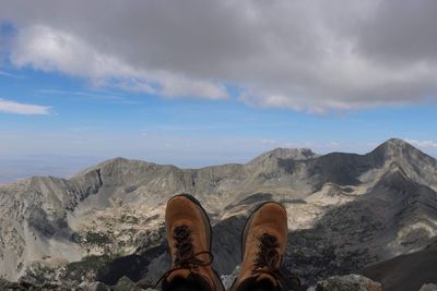 Low section of person against mountains