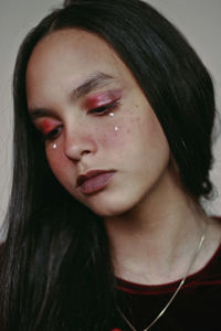 Close-up of young woman wearing make-up