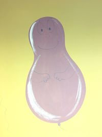 Close-up of yellow art against gray background