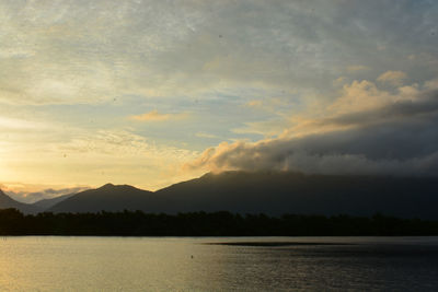 Scenic view of lake and mountains during sunset