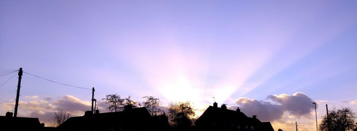 Low angle view of silhouette trees against sky at sunset