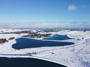 Aerial view of snowcapped mountain against sky