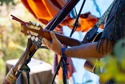 Midsection of man holding umbrella