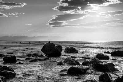 Rocks on beach against sky